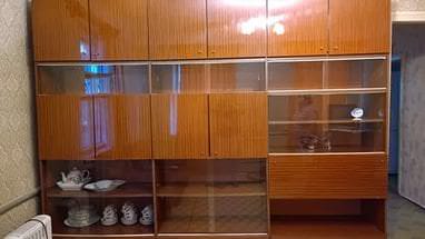 Витрина с деревянными шкафами для посуды в гостиной 