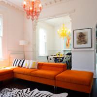 Мягкая мебель с оранжевыми подушками в интерьере гостиной