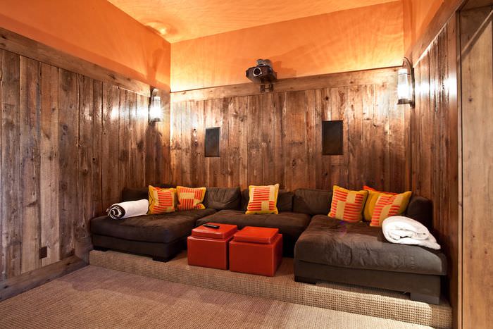 Интерьер домашнего кинозала с оранжевым потолком