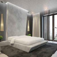 Белая кровать в спальне стиля минимализма
