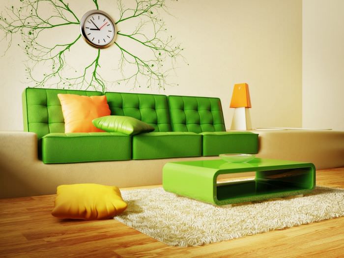 Оранжевая подушка на зеленом диване