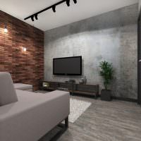 Черный телевизор в гостиной с кирпичной стеной