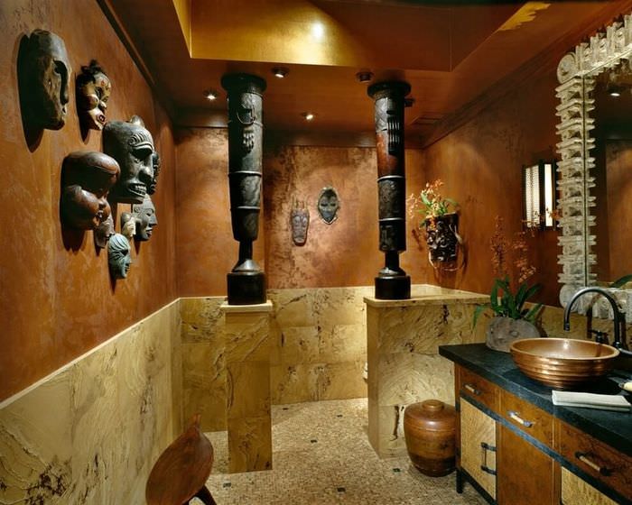 Маски африканских идолов на стене ванной комнаты